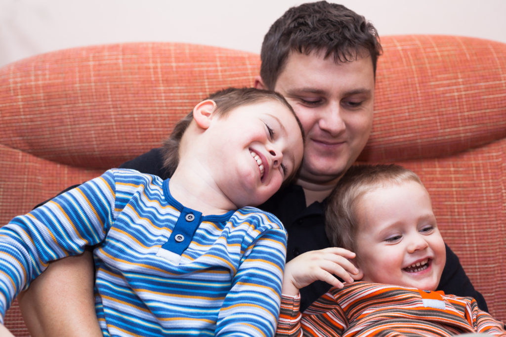 Image of a man reading to his children